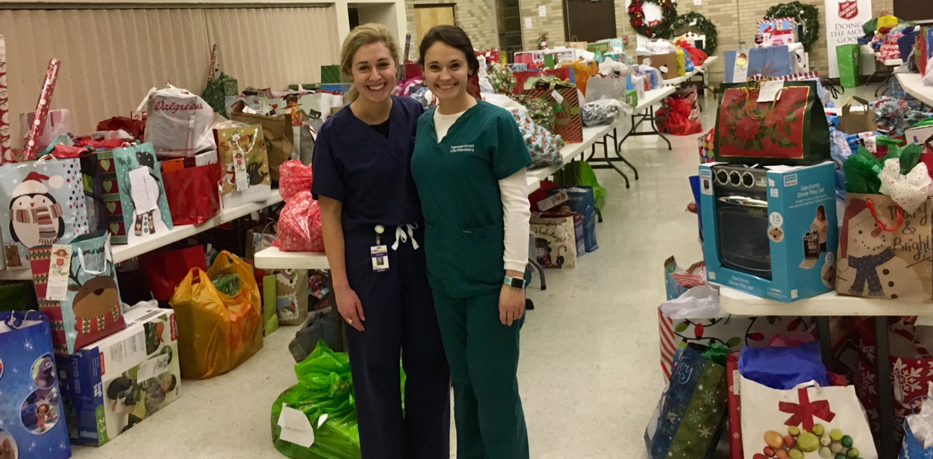 Emily Guarisco and Hannah Knott delivering dental school Angel Tree gifts to the Salvation Army
